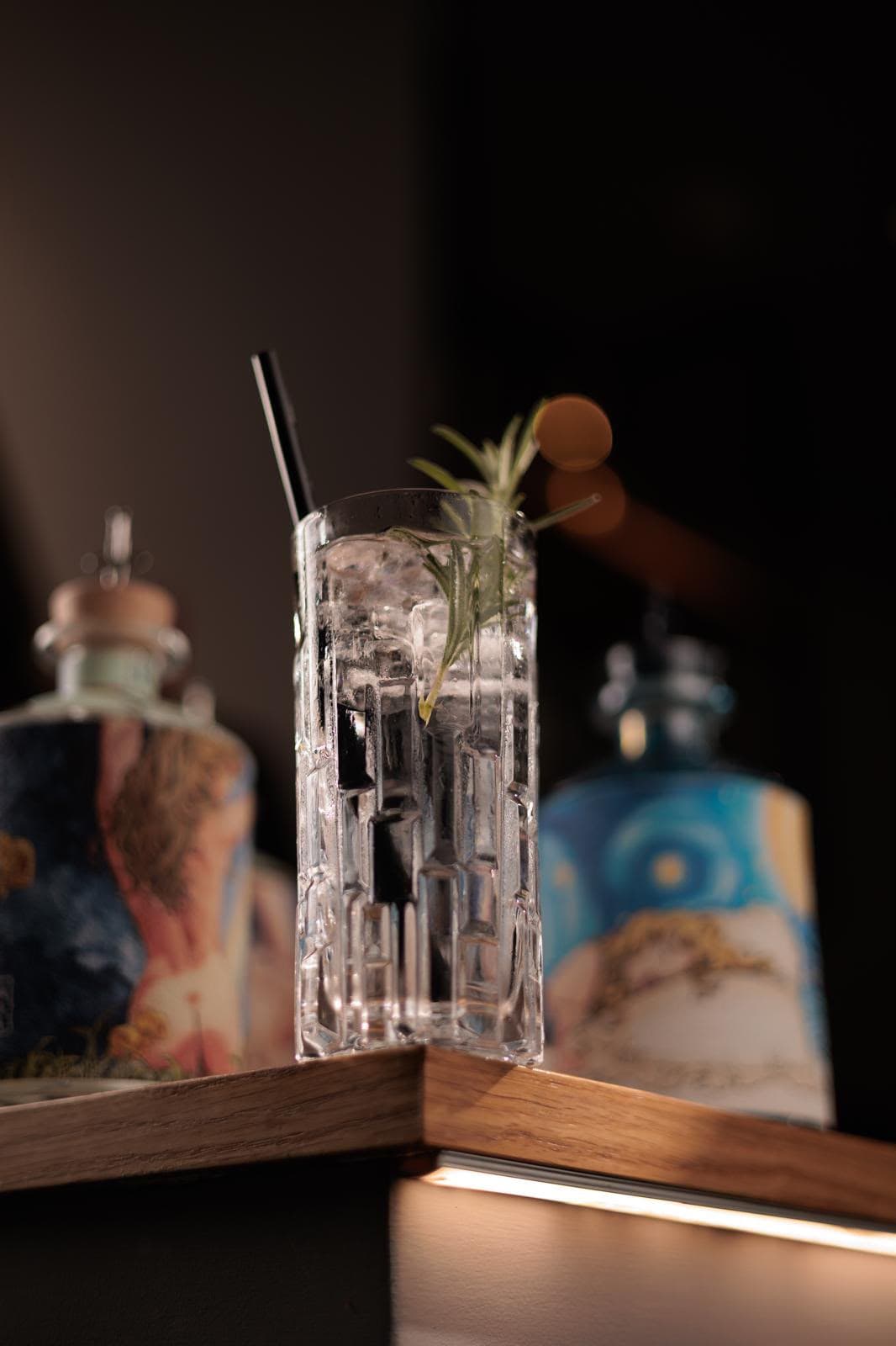 Cocktail con ghiaccio e rametto di rosmarino al bancone